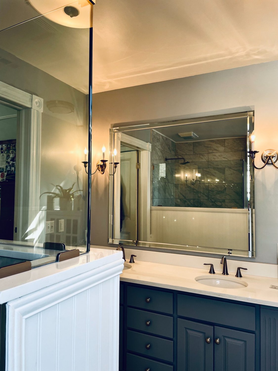 Frameless shower door beside freestanding soaking tub, natural light, Hampton Roads